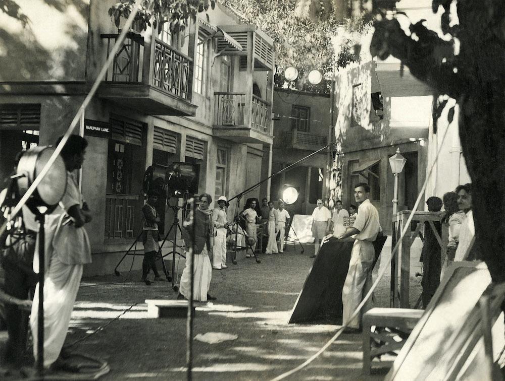 Comedian V. H. Desai rehearses a scene for Bhabhi (Prod. Bombay Talkies. 1938) while scores of crew members labour and wait alongside him. This image really captures the dispersed nature of filmmaking, an activity that takes place across and between diverse agents. (Image courtesy of the Josef Wirsching Archive/Alkazi Collection of Photography.)